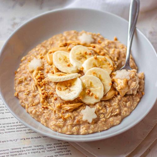 A bowl of creamy banana oatmeal with fresh fruits