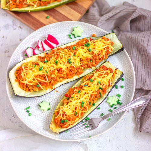 Stuffed vegan zucchini boats with vegan meat and cheese