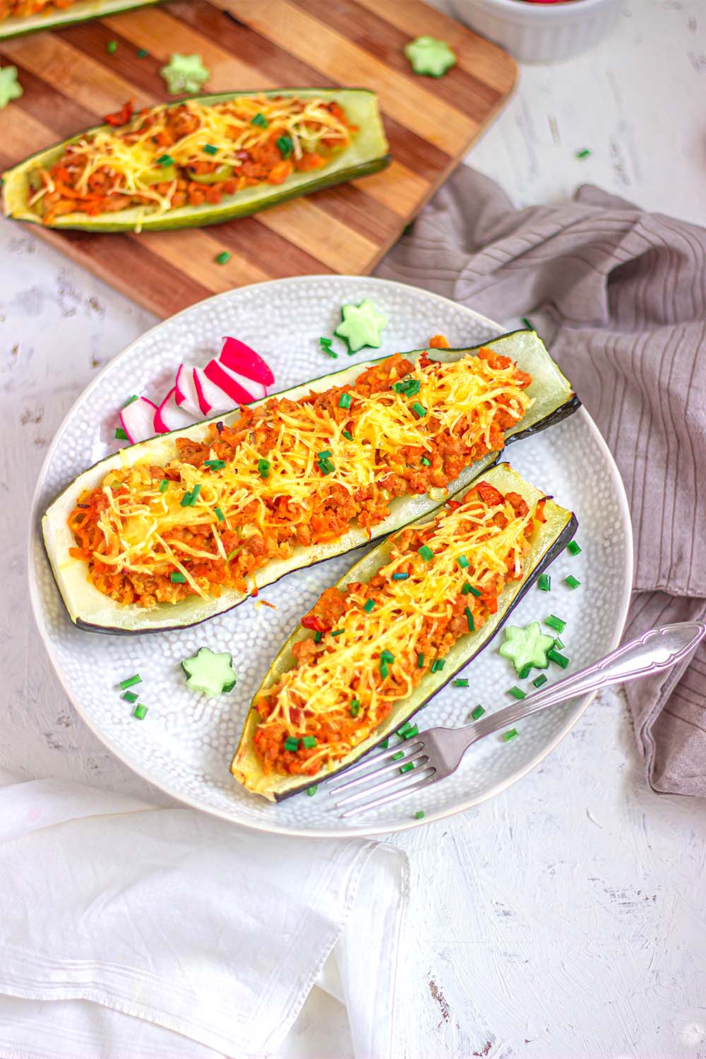 Stuffed vegan zucchini boats with vegan meat and cheese