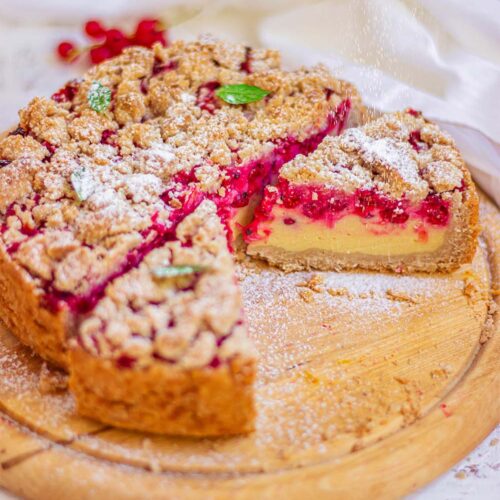 Vegan crumble cheesecake dusted with powdered sugar